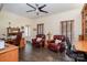 A traditional home office with hardwood floors, a ceiling fan, windows, and built-in shelving at 125 High Sail Ct, Mooresville, NC 28117