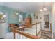 A casual living room located at the top of the stairs, with hardwood floors and neutral paint at 125 High Sail Ct, Mooresville, NC 28117