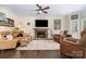Cozy living room features a stone fireplace, hardwood floors, and comfortable seating at 125 High Sail Ct, Mooresville, NC 28117