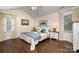 A cozy bedroom with a ceiling fan, hardwood floors, and a bed with two bedside tables at 125 High Sail Ct, Mooresville, NC 28117