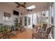 Relaxing screened-in porch with multiple seating areas and an outdoor tv at 125 High Sail Ct, Mooresville, NC 28117
