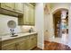 Custom bar area with granite countertops, custom cabinets, and hardwood floors at 1312 Lookout Cir, Waxhaw, NC 28173