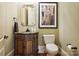 Bathroom with a custom vanity, decorative mirror, and updated toilet at 1312 Lookout Cir, Waxhaw, NC 28173