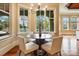 Sunlit breakfast nook with views of the pool and a stylish modern light fixture at 1312 Lookout Cir, Waxhaw, NC 28173