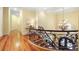 Hallway with wrought iron railing, hardwood floors, chandelier, and stairway to an open space at 1312 Lookout Cir, Waxhaw, NC 28173