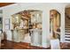 Open-concept kitchen featuring custom cabinets, granite countertops, and designer archways at 1312 Lookout Cir, Waxhaw, NC 28173