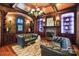 Cozy living room with a fireplace, built-in shelves, and leather sofas at 1312 Lookout Cir, Waxhaw, NC 28173