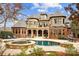 Expansive home exterior featuring a pool, spa, patios, manicured landscaping, and architectural design at 1312 Lookout Cir, Waxhaw, NC 28173