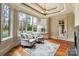 Comfortable sitting area features two chairs, large windows with backyard pool view, and an elegant chandelier at 1312 Lookout Cir, Waxhaw, NC 28173