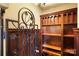 Custom wine cellar with wrought iron gate and wood shelving offers a sophisticated storage solution at 1312 Lookout Cir, Waxhaw, NC 28173
