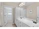 Bathroom with double sinks, white cabinets, and a large mirror at 137 Hunters Hill Dr, Statesville, NC 28677
