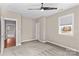 Carpeted bedroom featuring a ceiling fan, a window, and entry to another room at 137 Hunters Hill Dr, Statesville, NC 28677