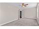 Carpeted bedroom features double doors, a window, and neutral walls at 137 Hunters Hill Dr, Statesville, NC 28677