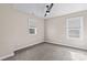 Neutral bedroom with a ceiling fan, carpet, and two windows at 137 Hunters Hill Dr, Statesville, NC 28677