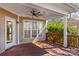 Covered deck featuring a ceiling fan and a large window for natural light and outdoor views at 137 Hunters Hill Dr, Statesville, NC 28677
