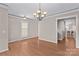 Bright dining room featuring hardwood floors, neutral walls, and an elegant chandelier at 137 Hunters Hill Dr, Statesville, NC 28677