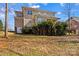 Backyard view of multi-story home with a deck and lush greenery at 137 Hunters Hill Dr, Statesville, NC 28677