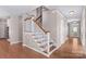 Inviting foyer with hardwood floors and elegant staircase, leading to the upper levels of the home at 137 Hunters Hill Dr, Statesville, NC 28677