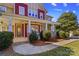 Inviting home featuring a charming front porch with stone accents and manicured landscaping at 137 Hunters Hill Dr, Statesville, NC 28677