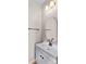 Clean half-bathroom featuring modern fixtures, a sleek vanity, and a stylish round mirror at 137 Hunters Hill Dr, Statesville, NC 28677