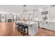 Open-concept kitchen featuring a large island, pendant lighting, and seamless flow into the living area with a fireplace at 137 Hunters Hill Dr, Statesville, NC 28677