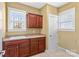 Laundry room featuring a utility sink, built in cabinets, countertops, and access to the outdoors at 137 Hunters Hill Dr, Statesville, NC 28677