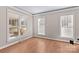 Bright living room with hardwood floors, large windows offering plenty of natural light and neutral paint at 137 Hunters Hill Dr, Statesville, NC 28677