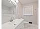 This bathroom boasts an updated vanity, and modern mirror providing a stylish and functional space at 1404 Nottingham Rd, Kannapolis, NC 28081