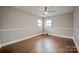 Spacious bedroom with hardwood floors, two windows, and neutral paint providing a bright and comfortable space at 1404 Nottingham Rd, Kannapolis, NC 28081