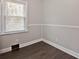 Cozy bedroom with neutral walls, new floors, and a large window for natural light at 1404 Nottingham Rd, Kannapolis, NC 28081