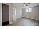 This bedroom features gray walls, light wood floors, a ceiling fan and closet at 1404 Nottingham Rd, Kannapolis, NC 28081