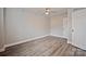 This bedroom features gray walls, light wood floors, and a ceiling fan at 1404 Nottingham Rd, Kannapolis, NC 28081