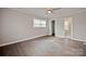 A spacious bedroom with hardwood floors, a ceiling fan, and natural light from a window at 1404 Nottingham Rd, Kannapolis, NC 28081