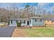 Charming single story home featuring gray siding, black shutters, and a well-maintained front yard at 1404 Nottingham Rd, Kannapolis, NC 28081