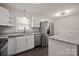 Bright kitchen featuring stainless steel appliances, white cabinets, and granite countertops at 1404 Nottingham Rd, Kannapolis, NC 28081