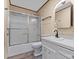 Bright bathroom featuring a shower-tub combo with sliding doors and a white vanity at 1536 Plyler Lake Rd, Gastonia, NC 28054