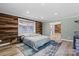 Bright bedroom features wood accent wall, large window, and en suite bathroom for a relaxing retreat at 1536 Plyler Lake Rd, Gastonia, NC 28054