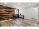 Bedroom with wood accent wall, wood floors, a window and closet door, creating a modern feel at 1536 Plyler Lake Rd, Gastonia, NC 28054