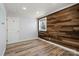 Inviting bedroom with hardwood floors, wood accent wall, and bright natural light at 1536 Plyler Lake Rd, Gastonia, NC 28054