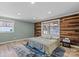 Bedroom featuring a unique wood accent wall and lots of natural light at 1536 Plyler Lake Rd, Gastonia, NC 28054
