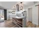 Spacious kitchen with center island, stainless appliances, and sliding barn door at 1536 Plyler Lake Rd, Gastonia, NC 28054