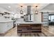 Bright kitchen with center island, stainless appliances, and sliding barn door at 1536 Plyler Lake Rd, Gastonia, NC 28054