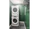 The laundry room features stacked washer and dryer units and a shelf for storage at 1536 Plyler Lake Rd, Gastonia, NC 28054