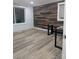 Bright room featuring wood accent wall, hardwood floors, and abundant natural light from a large window at 1536 Plyler Lake Rd, Gastonia, NC 28054