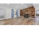 Charming living room featuring hardwood floors and a lovely accent wall with fireplace at 1536 Plyler Lake Rd, Gastonia, NC 28054