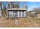 A gray storage shed with a greenhouse and a well-maintained exterior adds practicality and charm to the property at 1536 Plyler Lake Rd, Gastonia, NC 28054