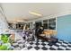 Versatile sunroom space with checkered flooring, large windows, and an exercise area at 1536 Plyler Lake Rd, Gastonia, NC 28054