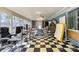 Expansive sunroom with checkered floors, offering versatile space for office or relaxation at 1536 Plyler Lake Rd, Gastonia, NC 28054
