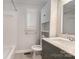 Clean bathroom with a vanity, tub, and built-in storage at 1831 Jameston Dr, Charlotte, NC 28209