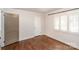 Comfortable bedroom featuring hardwood floors and window with wooden shutters at 1831 Jameston Dr, Charlotte, NC 28209
